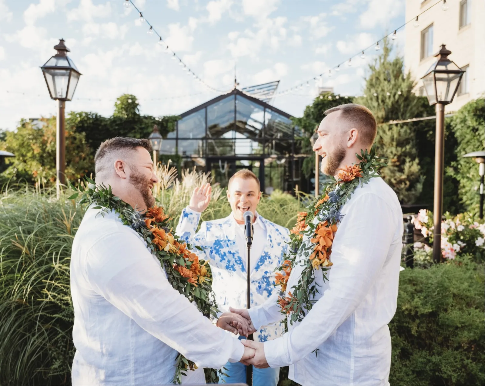 LGBTQ garden wedding ceremony with officiant Schwa Potter and two grooms wearing leis